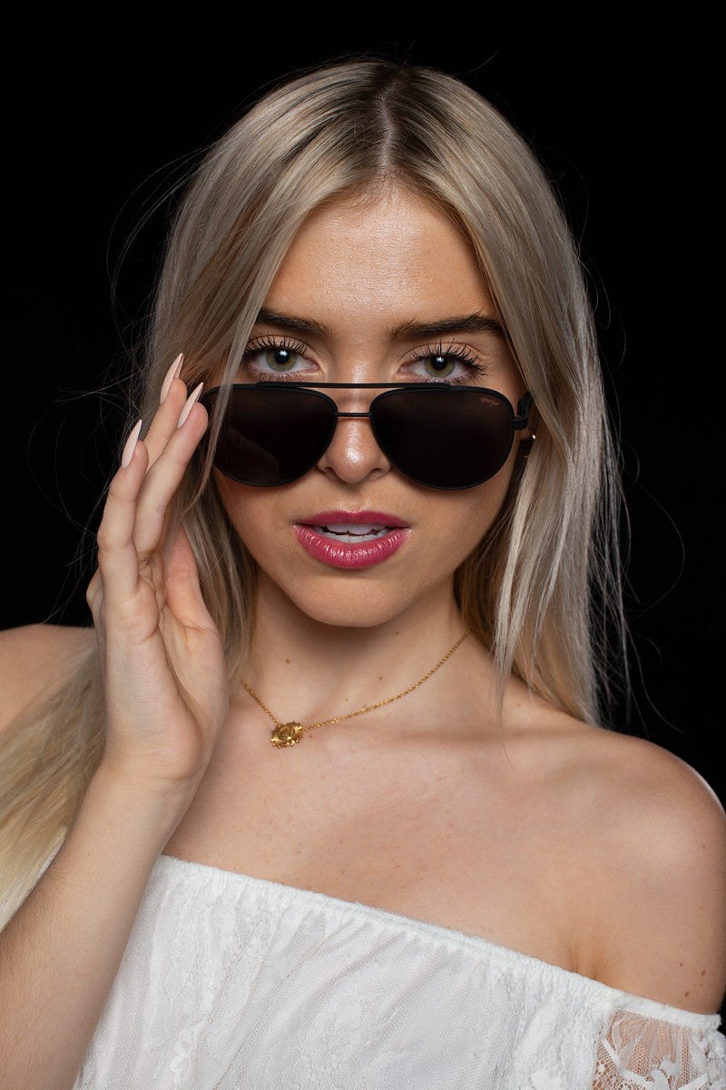 Young lady wearing stylish EyeDope aviator sunglasses called Maverick. Our aviator sunglasses are made in Italy. The name Maverick is taken from the Tom Cruise character in the Top Gun movie series.