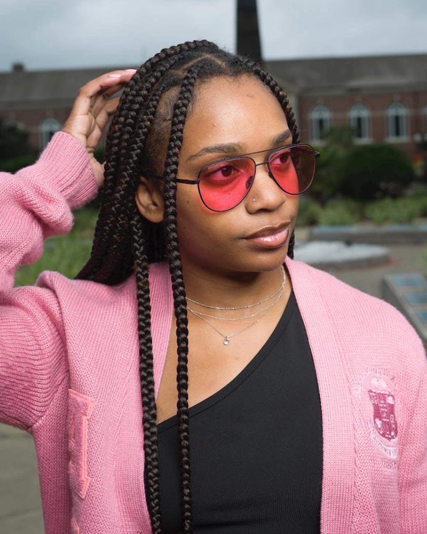 Female wearing EyeDope aviator with pink solid tint lenses.