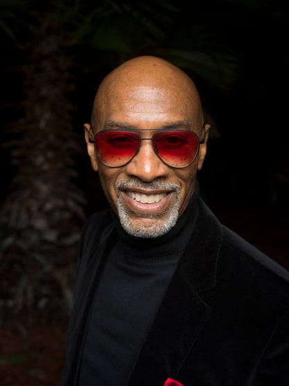 EyeDope founder Ron McCoy wearing aviator with red to clear lenses.